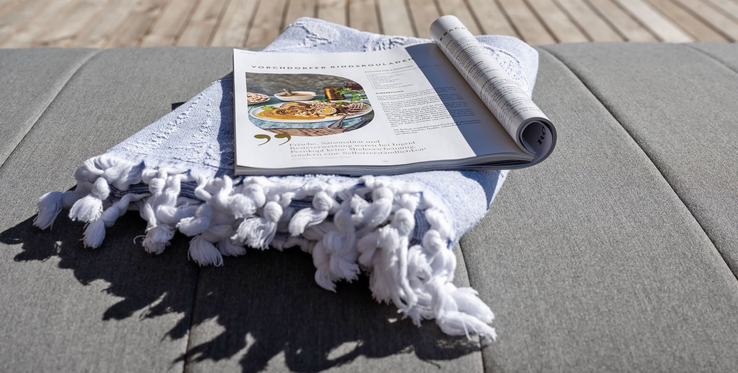 Decken und Lesestoff stehen bereit für einen gemütlichen Nachmittag am Pool