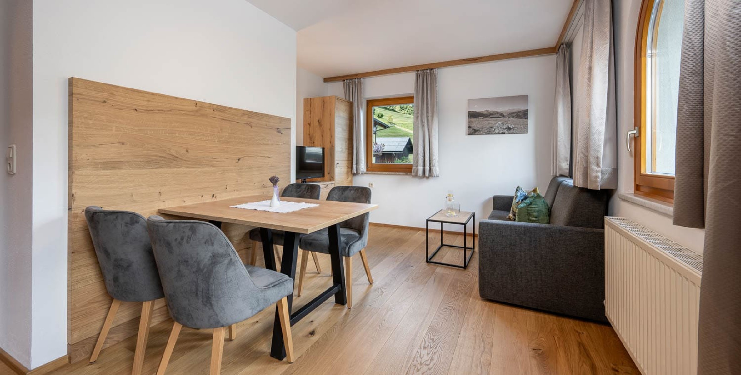 Wohnbereich mit Esstisch, Couch und TV